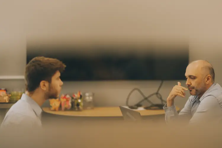Serous talking between two people in a boardroom